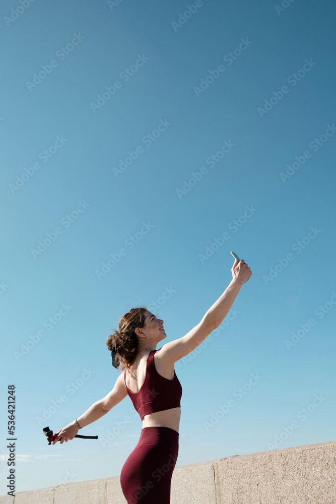 Young female taking selfie during her workout outdoors Young female taking selfie during her workout outdoors