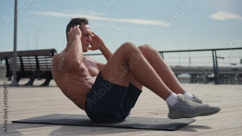 sport, fitness and healthy lifestyle concept - Caucasian man making abdominal exercises at home. Core training at home
