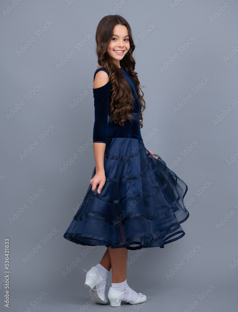 Fototapeta premium Full length of teenager child wearing ball dress. Happy girl face, positive and smiling emotions.