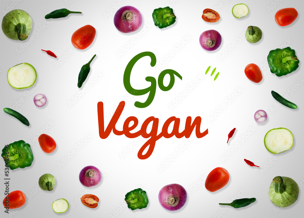 Go vegan background with fresh vegetables and typography in the center. Vegetable food concept design Go vegan background with fresh vegetables and typography in the center. Vegetable food concept design