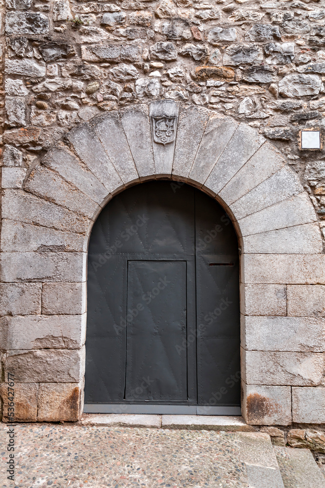 Detail from the Cathedral of Girona, ancient arch door with nailed metal door Detail from the Cathedral of Girona, ancient arch door with nailed metal door