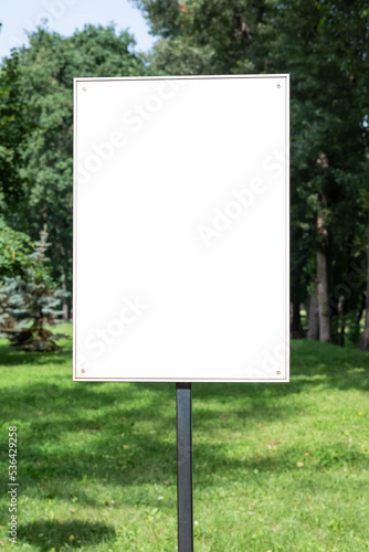 Advertising signboard with space for writing text on the background of the park on a sunny day.