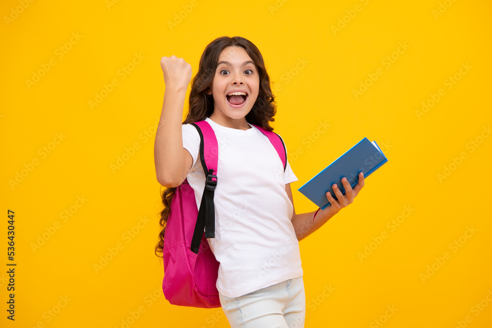 Amazed teen girl. Back to school. Teenager school girl hold book and copybook ready to learn. School children with school bag on isolated yellow studio background. Excited expression, cheerful and Amazed teen girl. Back to school. Teenager school girl hold book and copybook ready to learn. School children with school bag on isolated yellow studio background. Excited expression, cheerful and