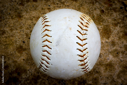 Dirty baseball on a field in a park in Central Florida