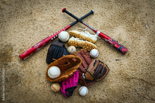 Close-up of Baseball Equipment including baseball gloves, balls, cleats and bats at park in Central Florida photo