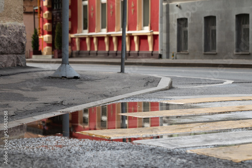 Wallpaper Mural Street corner. The building reflected in a puddle of water. Torontodigital.ca