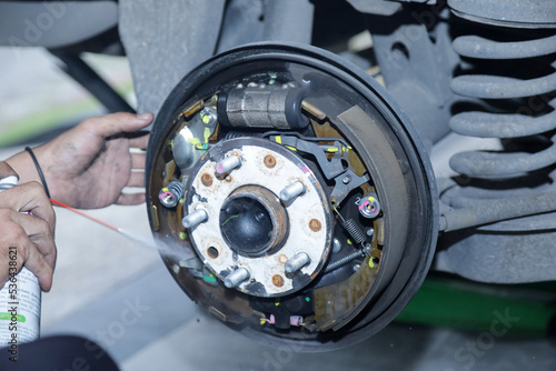 Mechanic repairing brake drums, replace new brake pads, hand brakes and cylindrical brake drums Rear brake drum set