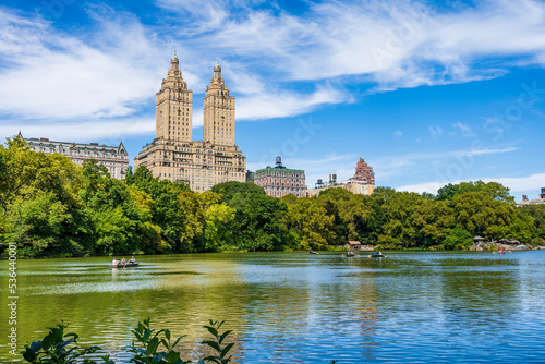 The Lake in Central Park with row boats and The San Remo hotel in the background, upper Manhattan, New York city, USA