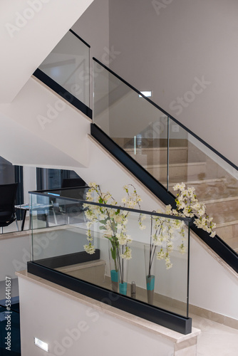 white interior with glass fence and stairs