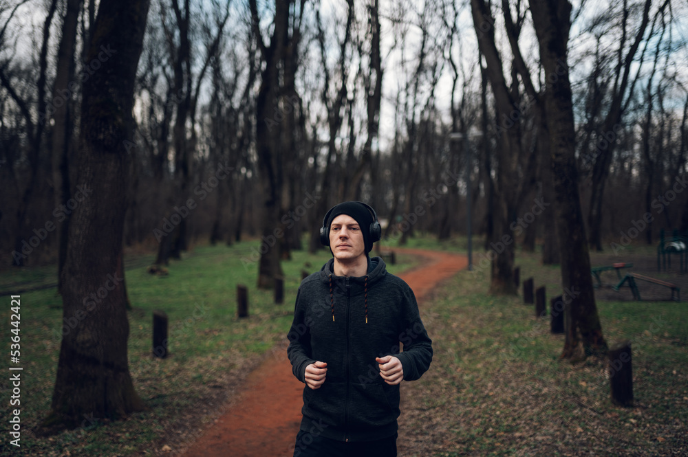 Young redhead man running in forest Young redhead man running in forest