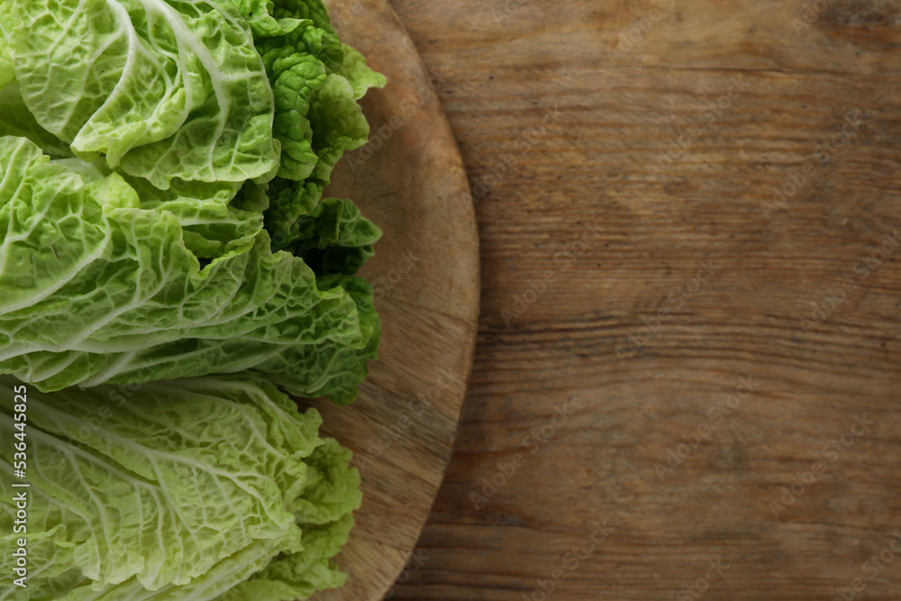 Fresh ripe leaves of Chinese cabbage on wooden table, top view. Space for text Fresh ripe leaves of Chinese cabbage on wooden table, top view. Space for text