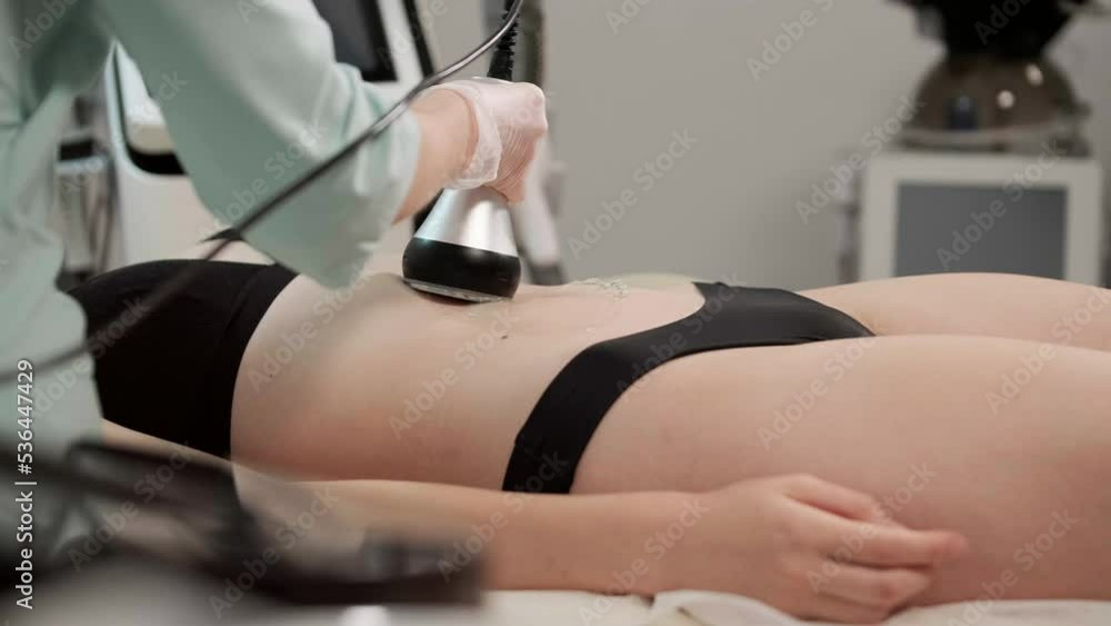 Cavitation body contouring treatment. Woman getting anti-cellulite and anti-fat Cavitation body contouring treatment. Woman getting anti-cellulite and anti-fat