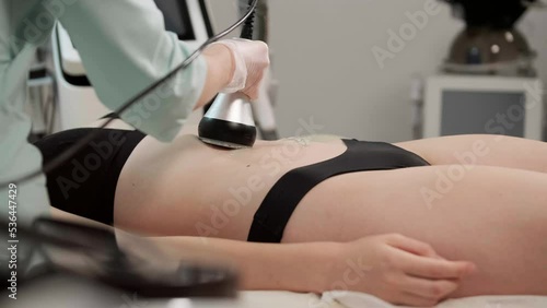 Cavitation body contouring treatment. Woman getting anti-cellulite and anti-fat 