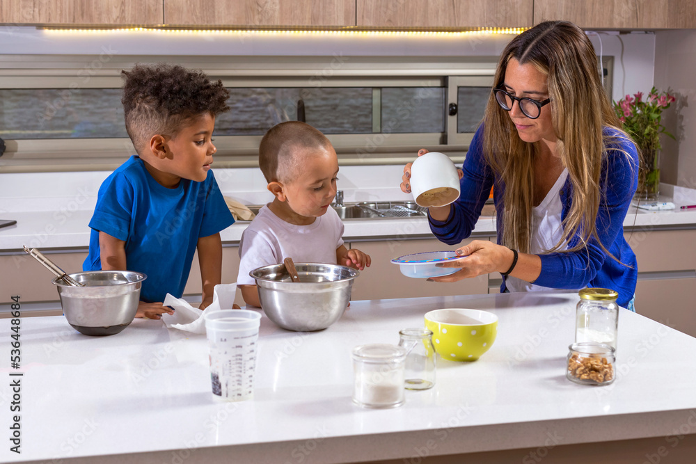Mother playing and sharing food preparation with her son and friend Mother playing and sharing food preparation with her son and friend