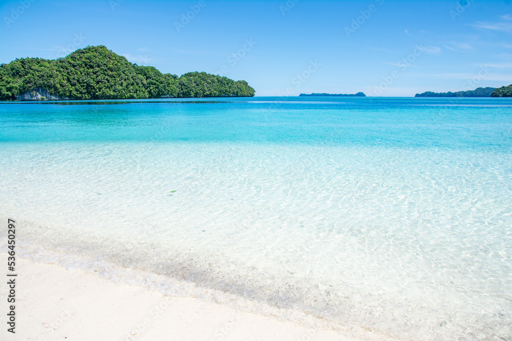 White sand and Blue ocean beach, view of Ulong island from Ngermeaus Island in Rock Islands Souther Lagoon, Koror state, Palau, Pacific