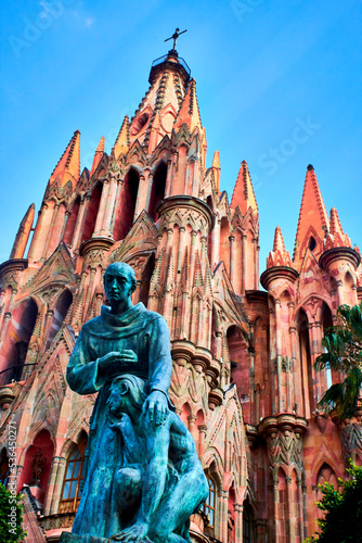 pink parish with neo gothic style of architecture with blue sky and sculture of 