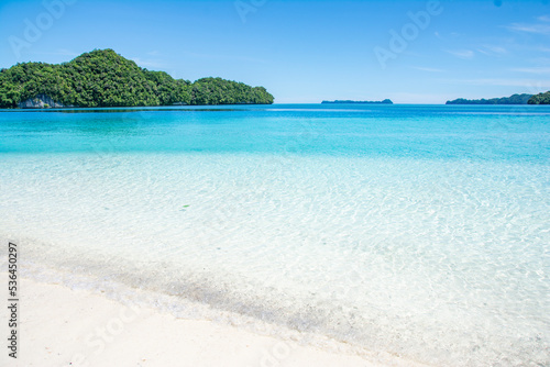 Fototapeta Naklejka Na Ścianę i Meble -  White sand and Blue ocean beach, view of Ulong island from Ngermeaus Island in Rock Islands Souther Lagoon, Koror state, Palau, Pacific