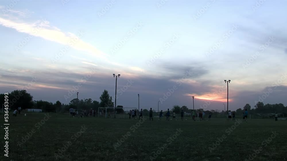 Group of High School Students playing Soccer at Sunset. Group of High School Students playing Soccer at Sunset.
