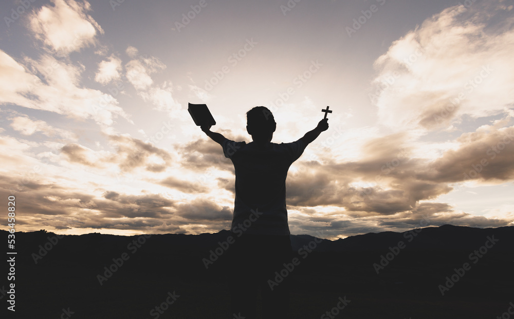 Silhouette of a woman with hands raised in the sunset concept for religion, worship, prayer and praise, Religious concepts Silhouette of a woman with hands raised in the sunset concept for religion, worship, prayer and praise, Religious concepts