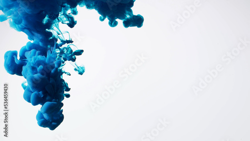 Abstract formed blue color dissolving water. Abstract cloud ink swirling water. Royalty high-quality stock photo Acrylic ink underwater form, abstract smoke pattern isolated on white background