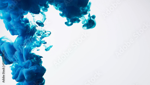 Abstract formed blue color dissolving water. Abstract cloud ink swirling water. Royalty high-quality stock photo Acrylic ink underwater form, abstract smoke pattern isolated on white background