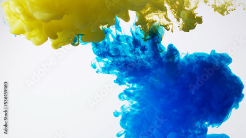 Abstract formed yellow blue color dissolving water. Abstract cloud ink swirling water. Royalty high-quality stock photo Acrylic ink underwater form, abstract smoke pattern isolated on white background