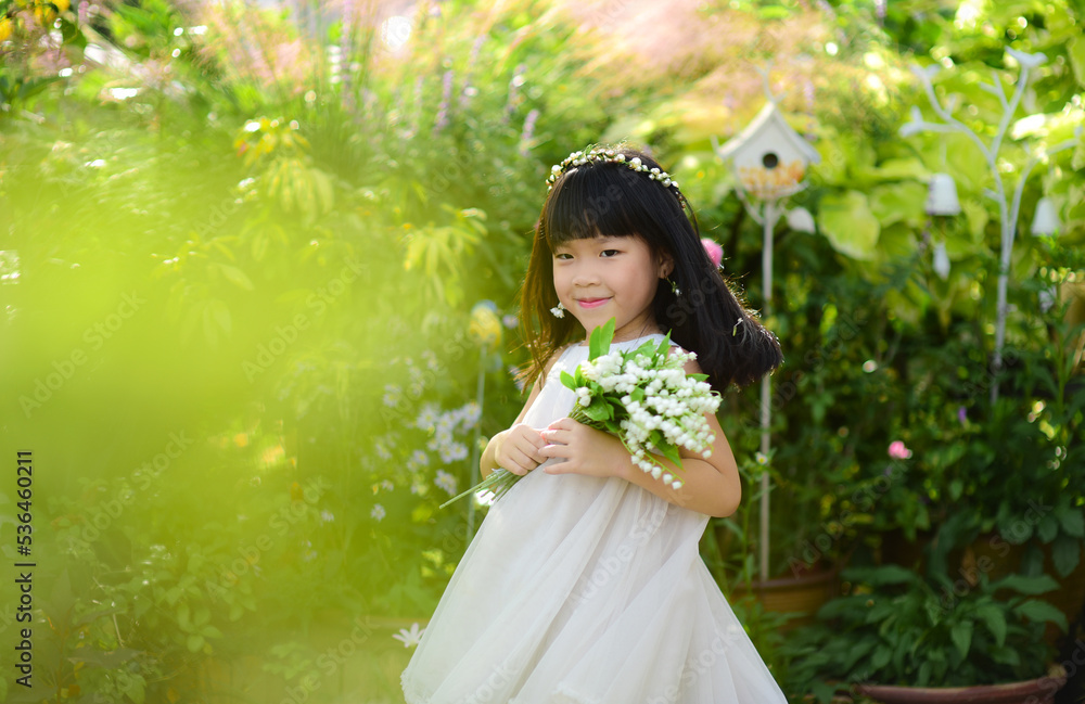 Smiling little girl holding flowers Smiling little girl holding flowers