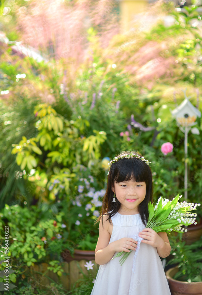 Smiling little girl holding flowers