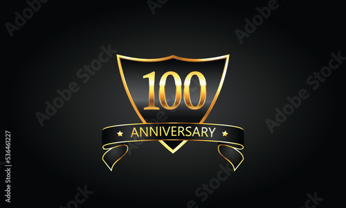 100 year anniversary logo with golden shield and ribbon. Dark concept anniversary.100th Anniversary celebration background. hundredth anniversary banner vector