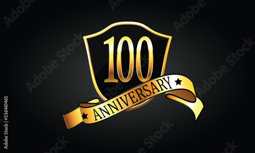 100 year anniversary logo with golden shield and ribbon. Dark elegant concept anniversary. 100th Anniversary celebration background. hundredth anniversary banner vector	