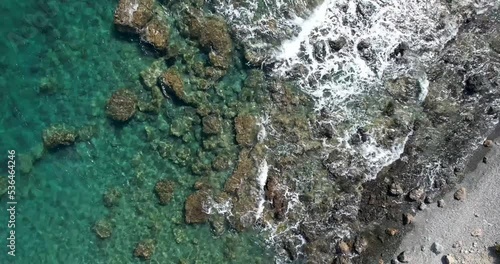 high angle of of a tropical reef with waves and green water