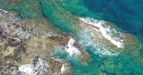 bird's eye view of waves crashing on a reef