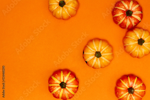 Halloween decorations concept, Top view of scary smiling pumpkins on orange background
