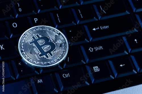 Bitcoin coins on compuer keyboard,symbol of electronic virtual money and mining cryptocurrency concept.Coin crypto currency bitcoin concept.Bitcoin on keyboard. photo