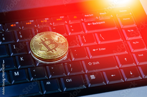 Bitcoin coins on compuer keyboard,symbol of electronic virtual money and mining cryptocurrency concept.Coin crypto currency bitcoin concept.Bitcoin on keyboard. photo