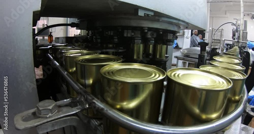 Canned food production plant , automated line. Conveyor belt in motion during the manufacture of canned food in cans.