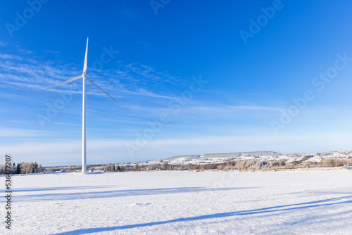 Beautiful landscape view with a wind turbine at winter