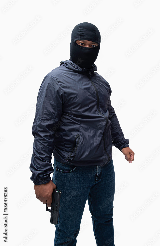 Burglar or terrorist. Holding pistol in various poses on background isolated with clipping path. Burglar or terrorist. Holding pistol in various poses on background isolated with clipping path.
