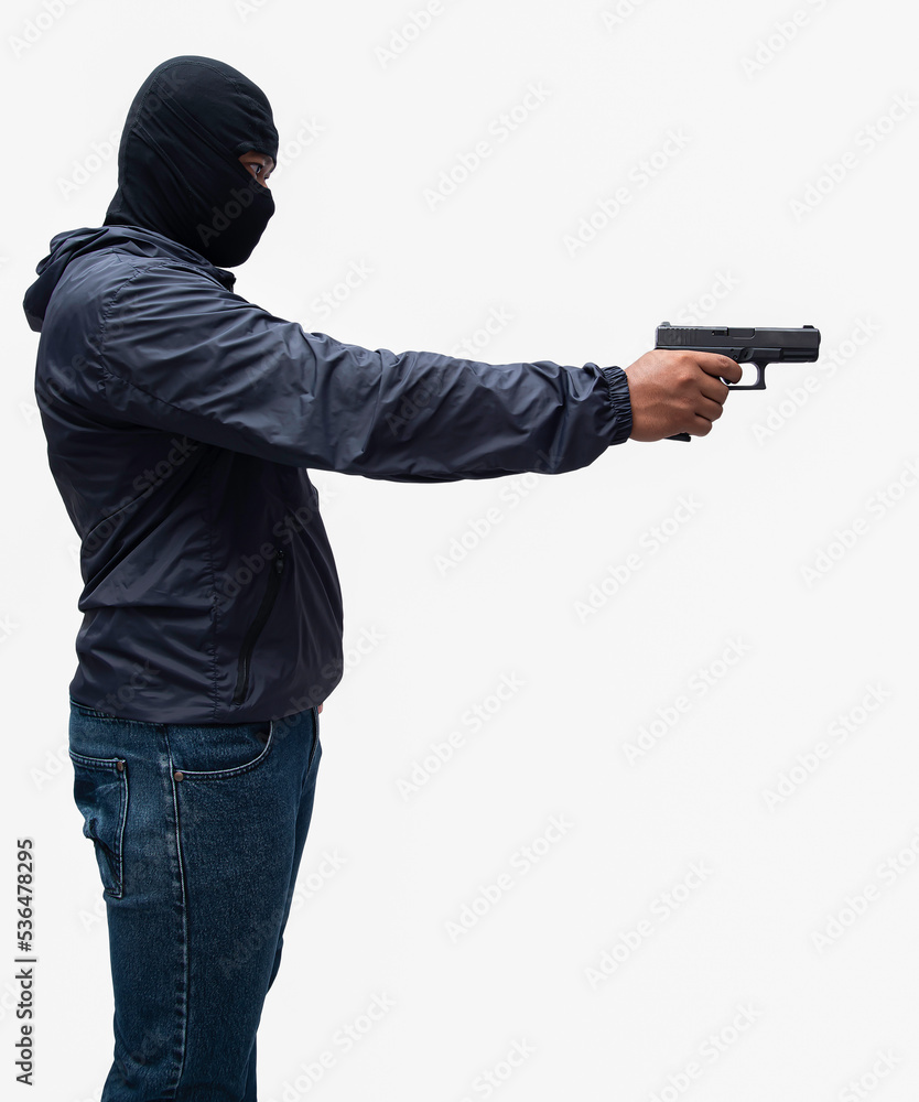 Burglar or terrorist. Holding pistol in various poses on background isolated with clipping path. Burglar or terrorist. Holding pistol in various poses on background isolated with clipping path.
