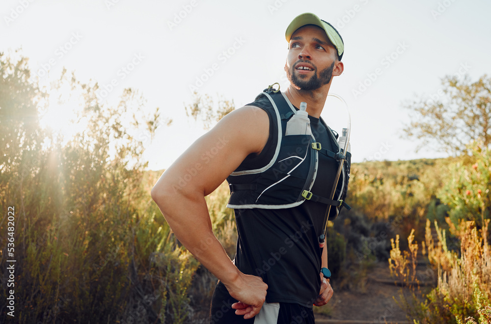 Wellness, man or hiking fitness focus in nature for exercise, training or workout. Healthy, health or runner athlete in forest for running, sports or motivation for race, event or marathon in summer