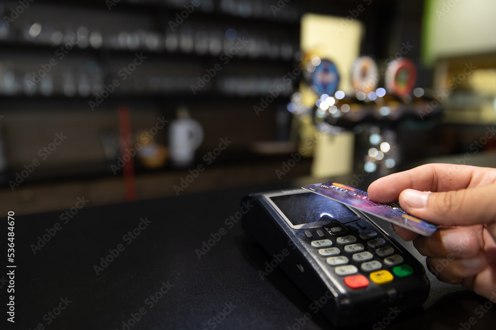 Credit card payment. A young man makes a payment with a credit card.