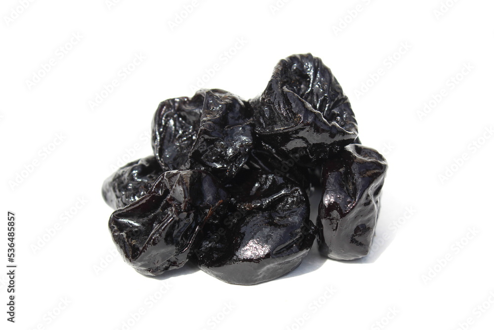 On a white background - a bunch of black prunes. On a white background - a bunch of black prunes.