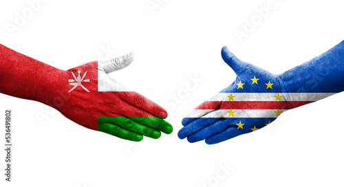 Handshake between Cape Verde and Oman flags painted on hands, isolated transparent image.