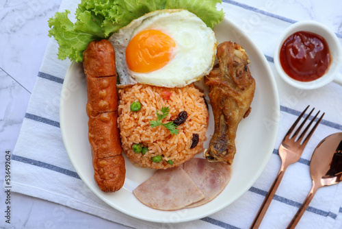 Fried rice Thai Style Served fried Chicken, Sausage ,Ham and Fried Egg - In Thai called American fried rice at top view 
