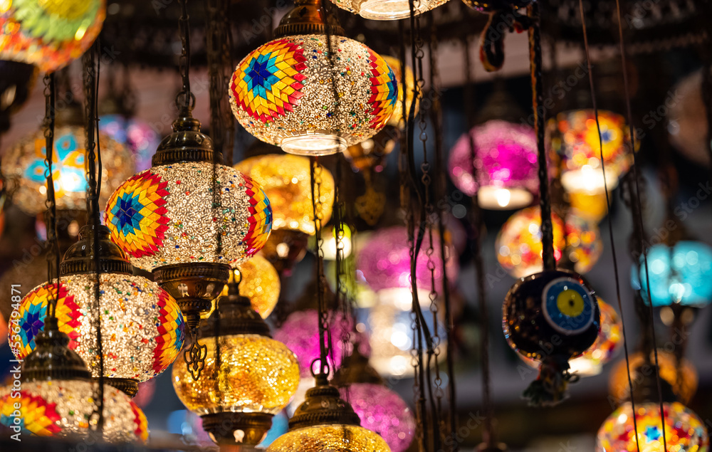 Colorful hanging lights from turkey on display for sale in Diwali fair to brighten the rooms. Artistic selective focus background.