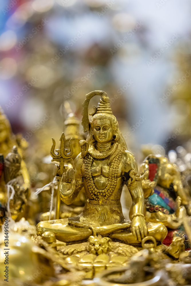 Hindu god Shiv idol made of brass with blur background. Selective focus on Shiv idol.