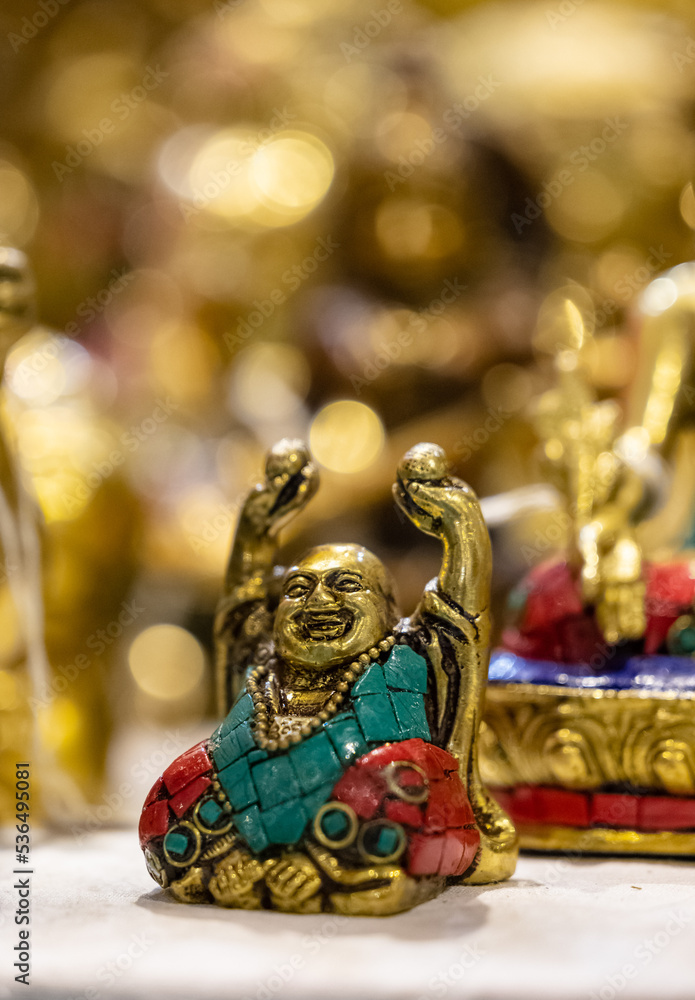 Fototapeta premium Laughing Buddha idol made of brass with blur background. Selective focus on laughing buddha.