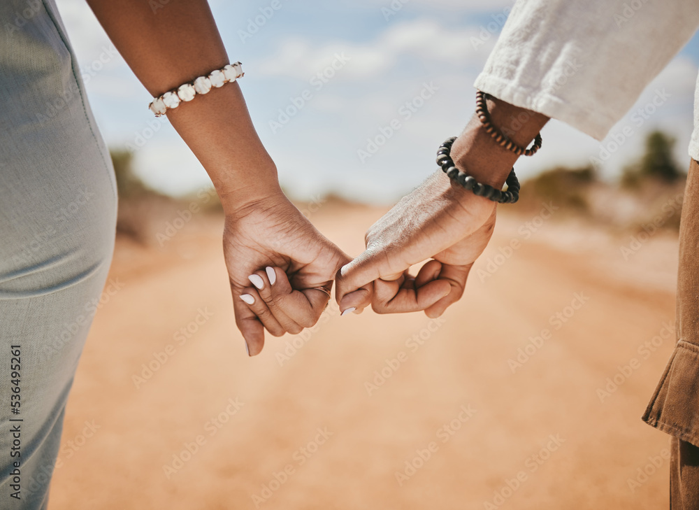 Couple walking, promise and hook fingers for support, trust and love in nature outdoors. Closeup man, woman and connect pinky hands in hope, respect and commitment link of save the date relationship