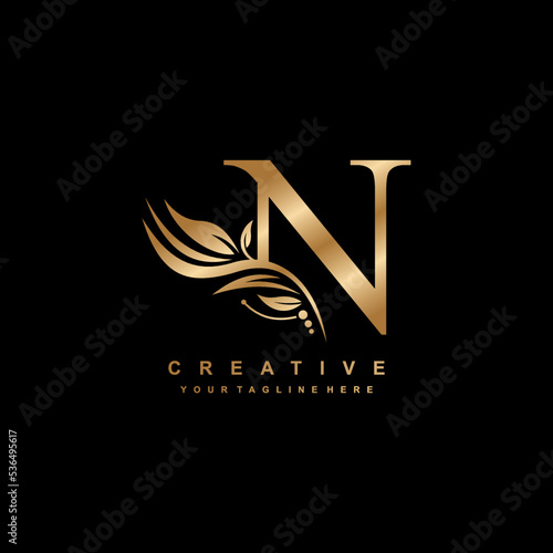 gold letter N logo design with luxurious and beautiful leaf ornament. N Monogram. N typography. gold feather logo. initial letter N logo