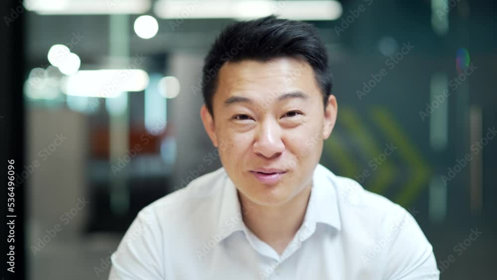 Office worker, Happy Asian Man employee coach or teacher speaks look at camera Webcam view Sitting at work in workplace room conference, meeting or study remotely online lecturer is talking education Office worker, Happy Asian Man employee coach or teacher speaks look at camera Webcam view Sitting at work in workplace room conference, meeting or study remotely online lecturer is talking education